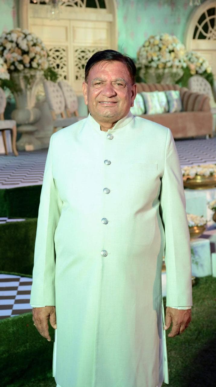 Nanu Maharaj, Vedic astrologer, smiling warmly in a pale green sherwani